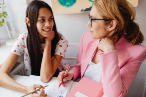A 10 to 13 year old girl and a teacher collaborate on a financial education, promoting learning and connection.